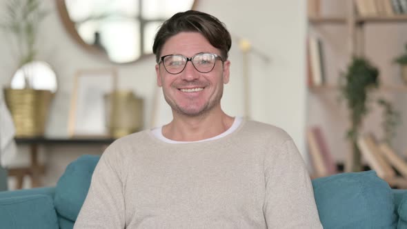 Middle Aged Man Smiling at Camera at Home 