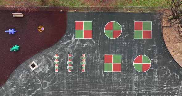 Playground for school recess. Hopscotch four square and riding animals. Descending top down aerial v