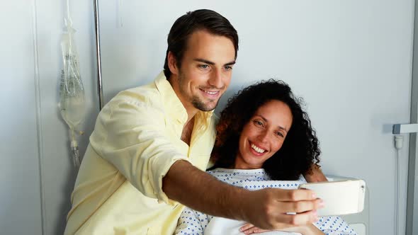 Couple taking selfie on mobile phone in ward