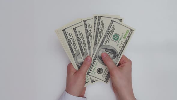 Closeup of Female Hands Counting Dollars