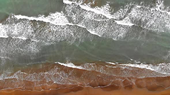 Aerial view of beach with breaking waves