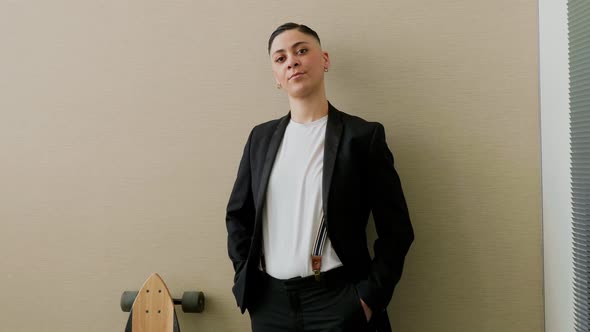 Confident young businesswoman standing in office, smiling