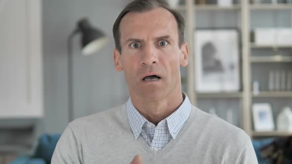 Portrait of Amazed Surprised Middle Aged Man Wondering