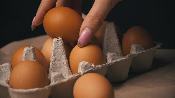 The Broken Egg Lies in the Container Among the Whole Eggs