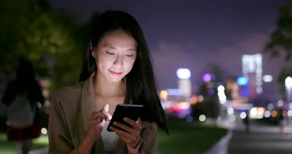 Woman use of smart phone at night