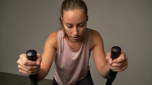 Dedicated Woman Training on Stationary Bike