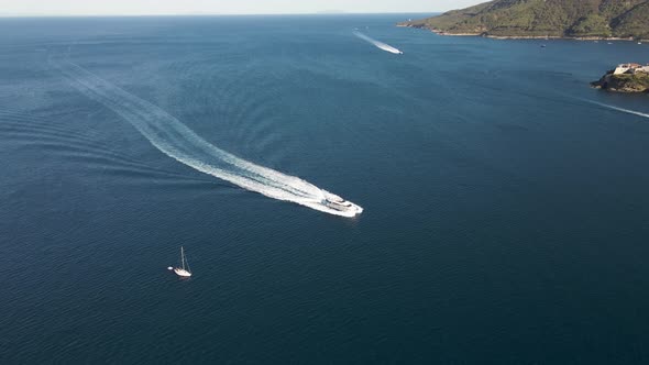 Aerial view of a motorboat along the coast, Elba Island, Italy.