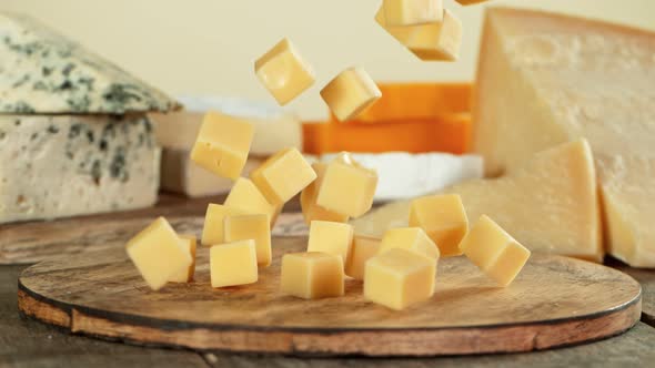 Super Slow Motion Shot of Cheese Cubas Falling on Wooden Board at 1000 Fps