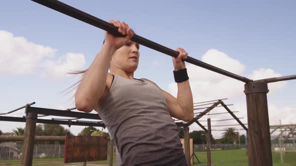 Young woman training at an outdoor gym bootcamp