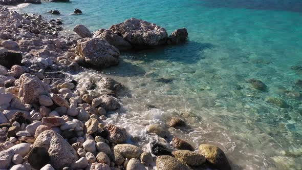 Rocky Shore with Stones and Blue Transparent Sea Water