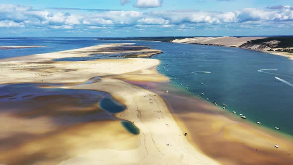 Arcachon Bassin France over Banc d'Arguin with boats anchored on the south passage, Aerial dolly out