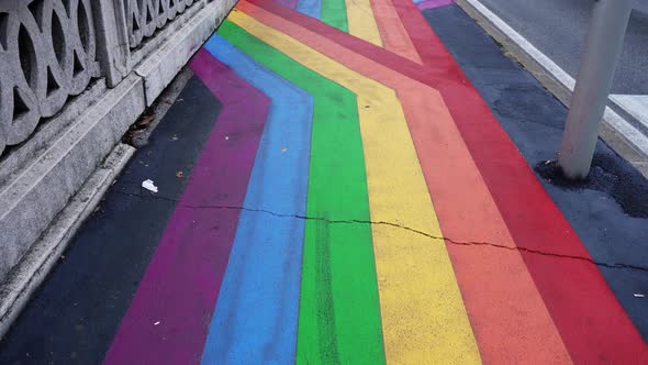 Long Asphalt Sidewalk with Bright Pride Flag Vertical Lines