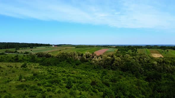 Aerial drone view of a flying over the rural agricultural landscape.