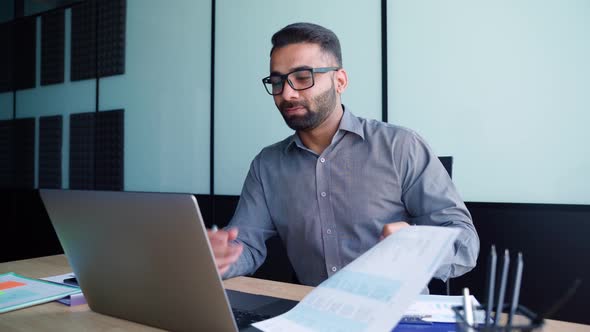 Young Latin Indian Financier Manager Having Working Video Call on Pc in Office