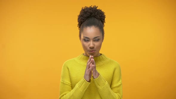 Sly Afro-American Girl Having Idea, Tricky Plan, Isolated on Yellow Background