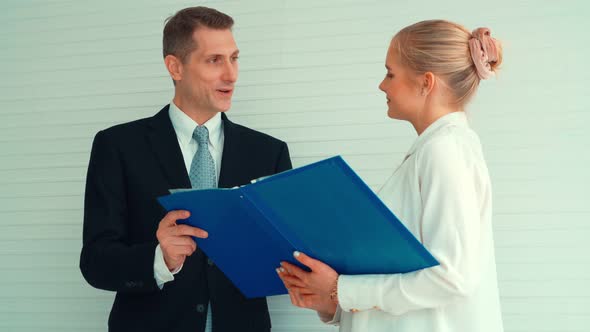 Two Business People Talk Project Strategy at Office