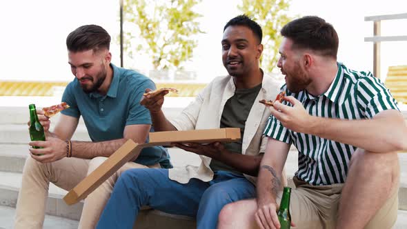 Male Friends Eating Pizza with Beer on Rooftop