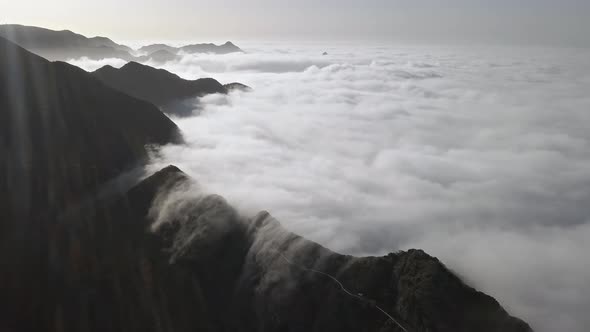Flight Over Clouds and Mountain Road in Anaga, Tenerife