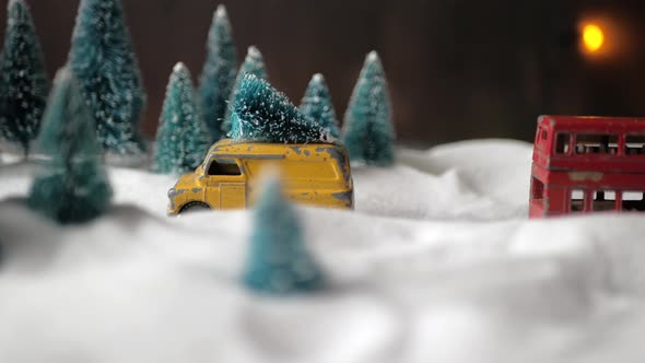 Winter Forest Miniature with a Small Yellow Toy Car with a Christmas Tree on the Roof, Double-decker