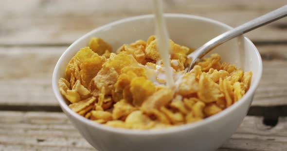 Video of cereals in ceramic bowl on wooden kitchen worktop