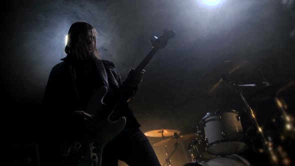 Rock Musician Playing Bass Guitar in Record Studio