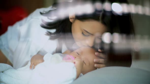 MotHer Take Care Baby Asleep and Sucking Milk From Bottle