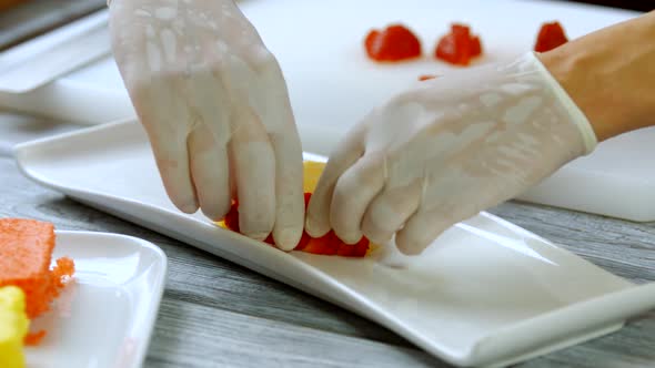 Hands Put Slices of Strawberry.