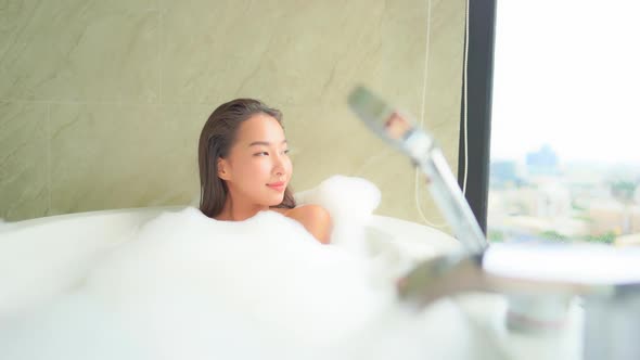 Young asian woman relax in bathtub