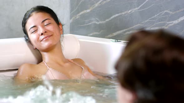 Middle Eastern Woman Enjoying Jacuzzi