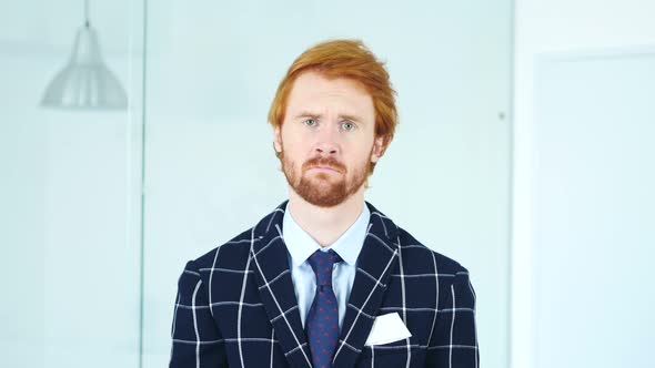 Sad Upset Redhead Businessman with Red Hairs in Office