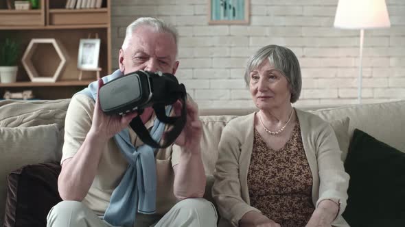 Senior Couple Inspecting VR Headset