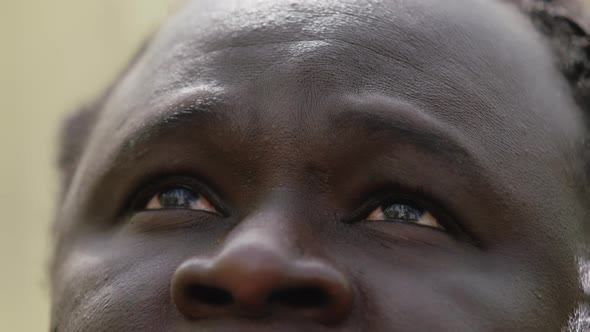 Close Up Shot of African Man with Red Eyes Looking Up