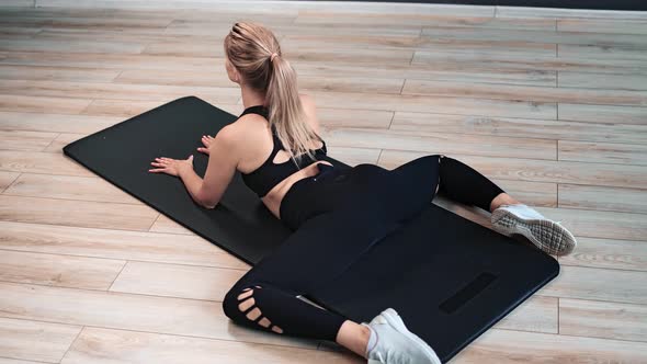 Sports Girl on Floor Demonstrate Flexibility During Pilates