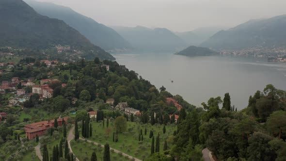 Aerial of beautiful lake. Drone pulling back over tree covered mountain