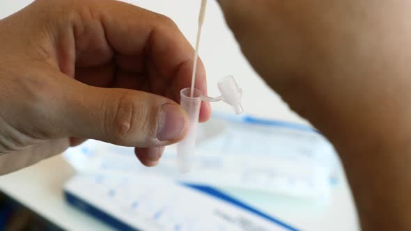 Man Hands Making Self Testing on Coronavirus and Stirring Swab in Reagent