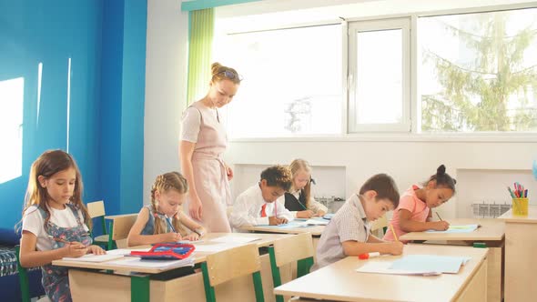 Female Teacher Teaching Group of Teenagers in High School Lesson