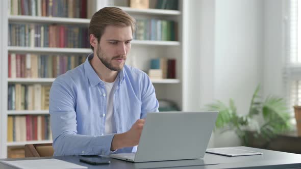 Man Having Wrist Pain While Using on Laptop