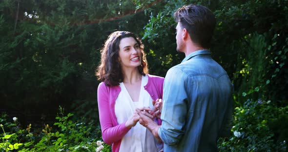 Romantic couple interacting with each other in garden