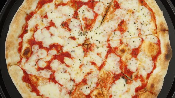 Top View of Fresh Baked Pizza with Tomatoes and Cheese Mozzarella Rotate on Tray