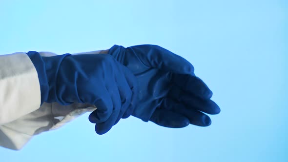 Close-up of the Doctor Wearing Rubber Gloves