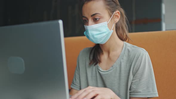 Mixed Race Woman Medical Mask Looks Straight at Camera