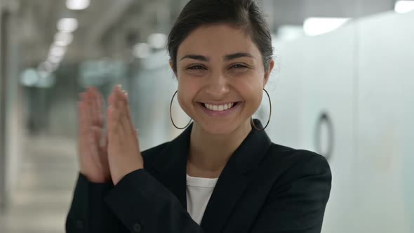 Portrait of Excited Young Indian Businesswoman Clapping