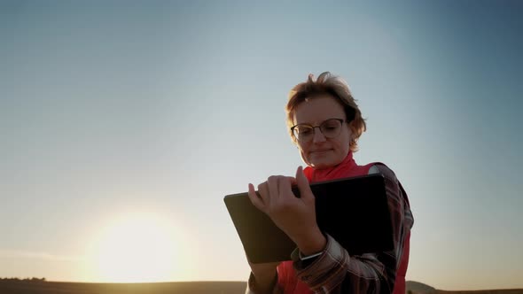 Farmer Woman Working with Tablet in Field Analyzes Quality of Crop Before Harvesting