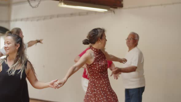 Focused Mature Woman Dancing with Female Teacher in Studio