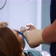 Dentist Performs a Procedure for Removing a Cofferdam to Patient - VideoHive Item for Sale