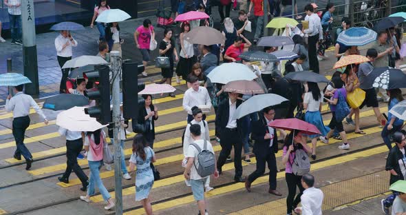 People cross the street in city at rain day