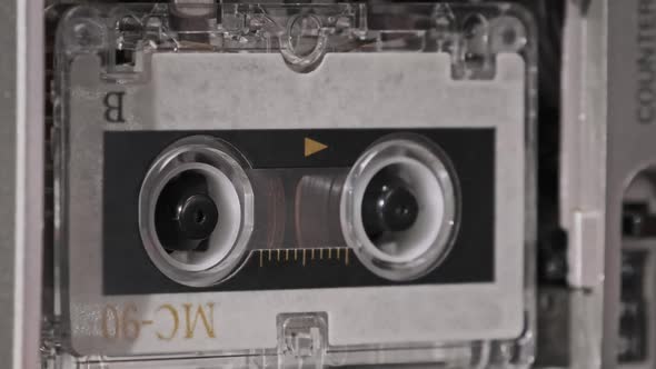 Vintage Audio Tape with a Blank Label Spinning in Cassette Recorder Closeup