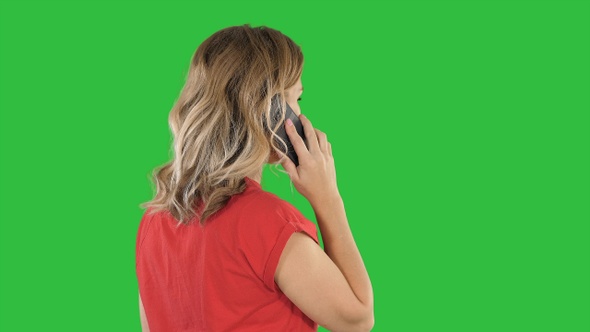 Woman talking on the phone on a Green Screen, Chroma Key.