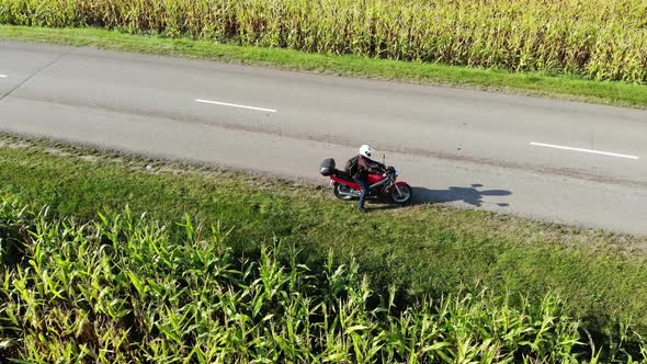 Motorcycle Riding By Country Road on Sunset, Beautiful Adventure Travel Footage Shot From Drone, Top