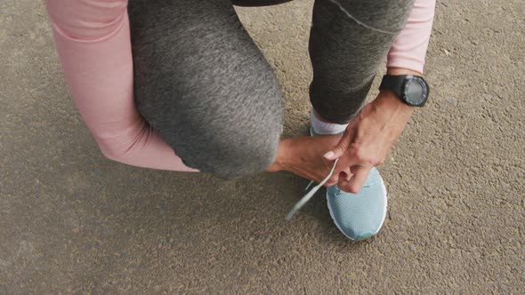 Close up of woman tying shoe laces